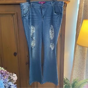 Never worn. These distressed Jeans have a slight flair at bottom.